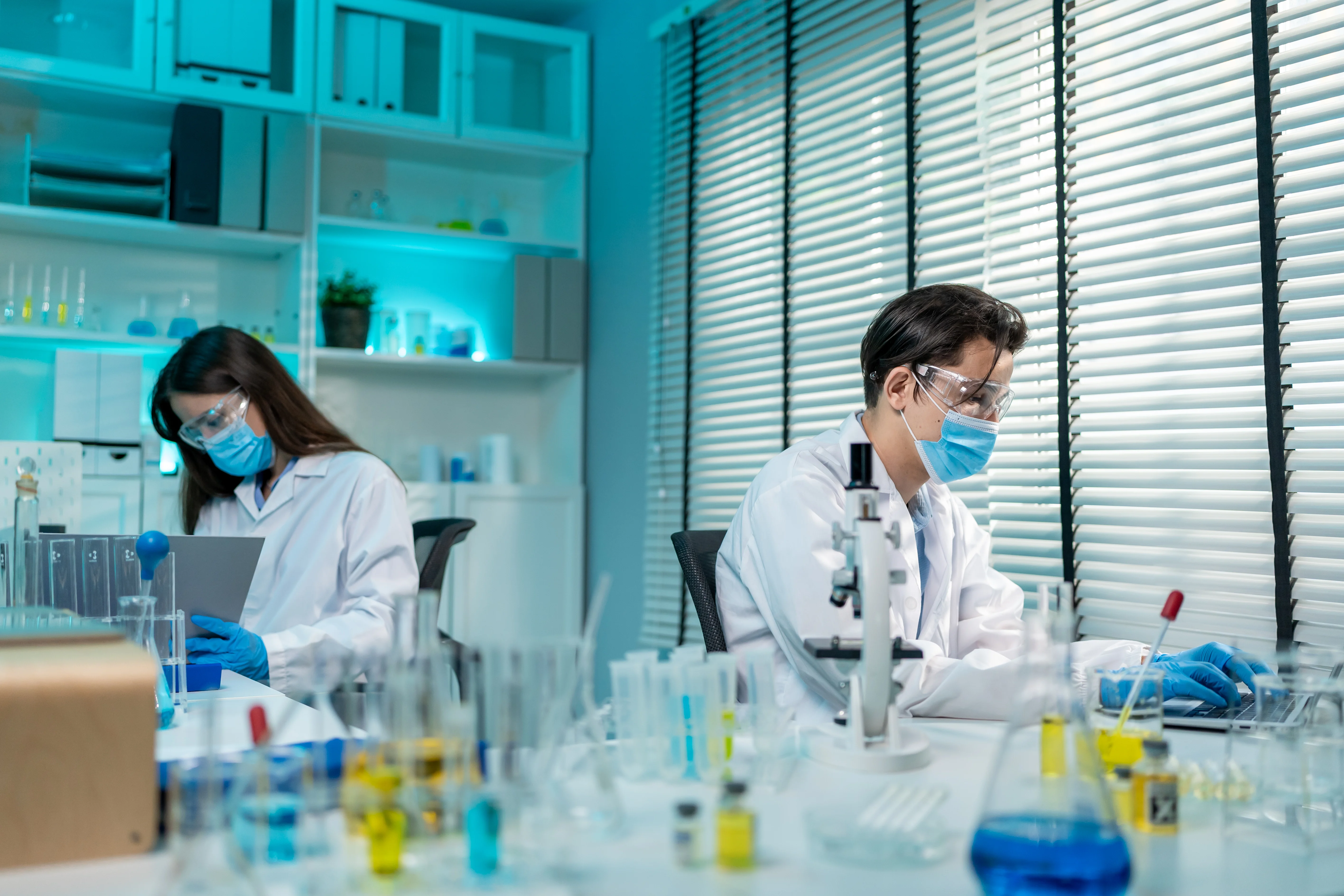 Scientists using the BioSure platform in a modern microbiology lab